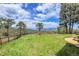 Expansive backyard featuring green grass, mature trees, and breathtaking mountain scenery at 1007 Nob Hill Rd, Evergreen, CO 80439
