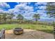 Beautiful backyard with a stone fire pit, lush lawn, and panoramic mountain views at 1007 Nob Hill Rd, Evergreen, CO 80439
