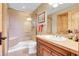A neutral toned bathroom featuring a glass shower with bench, white toilet and wooden vanity at 1007 Nob Hill Rd, Evergreen, CO 80439