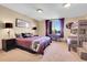 Well-lit bedroom with a queen-sized bed, twin bunk beds, dark furniture and nature view window at 1007 Nob Hill Rd, Evergreen, CO 80439