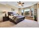 Bright bedroom with decorative pillows, ceiling fan, and a window bench with mountain views at 1007 Nob Hill Rd, Evergreen, CO 80439