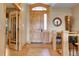 Grand foyer with wood floors, decorative tile, and a custom wood door at 1007 Nob Hill Rd, Evergreen, CO 80439