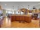 Open concept kitchen featuring wood floors, granite counters, and easy access to dining and living areas at 1007 Nob Hill Rd, Evergreen, CO 80439