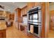 Gourmet kitchen with wood floors, stainless appliances, double ovens, and a desk area at 1007 Nob Hill Rd, Evergreen, CO 80439