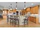 Spacious kitchen island featuring granite counters, pendant lighting, and counter seating at 1007 Nob Hill Rd, Evergreen, CO 80439