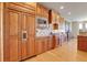 Gourmet kitchen with stainless appliances, custom cabinets, granite counters, and wood floors at 1007 Nob Hill Rd, Evergreen, CO 80439
