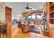 Open-concept living room with hardwood floors, stone fireplace, and mountain views at 1007 Nob Hill Rd, Evergreen, CO 80439
