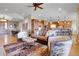 Bright living room flowing into the kitchen with hardwood floors and mountain views at 1007 Nob Hill Rd, Evergreen, CO 80439