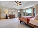 Spacious main bedroom featuring a tray ceiling, large windows, and scenic views at 1007 Nob Hill Rd, Evergreen, CO 80439