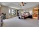 Spacious main bedroom featuring large windows with scenic views, a ceiling fan, and ensuite bathroom access at 1007 Nob Hill Rd, Evergreen, CO 80439