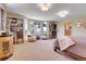 Serene main bedroom with scenic window views, cozy seating, and elegant furnishings at 1007 Nob Hill Rd, Evergreen, CO 80439