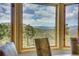 Breathtaking mountain views from the dining room with natural light and scenic beauty at 1007 Nob Hill Rd, Evergreen, CO 80439