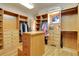 Large walk-in closet with built in shelving, drawers, and wood flooring at 1007 Nob Hill Rd, Evergreen, CO 80439