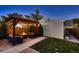 Landscaped backyard with a patio, pergola with string lights, and an outdoor seating area with a fire pit at 340 S Logan St, Denver, CO 80209