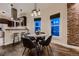 Cozy dining area featuring a round table, modern lighting, and exposed brick, creating a charming and inviting atmosphere at 340 S Logan St, Denver, CO 80209