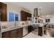 Well-lit kitchen with stainless steel appliances and an open view into the living room at 340 S Logan St, Denver, CO 80209