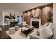 Stylish living room featuring an exposed brick wall, cozy fireplace, and modern furnishings, perfect for entertaining at 340 S Logan St, Denver, CO 80209