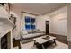 Inviting living room with a cozy fireplace, large window, and elegant furnishings, perfect for relaxing and unwinding at 340 S Logan St, Denver, CO 80209