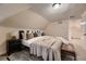 Serene bedroom with plush bedding, a window view and a leather bench at 340 S Logan St, Denver, CO 80209