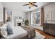 Bright bedroom with a decorative fireplace, hardwood floors, and ample natural light at 1563 N Lafayette St, Denver, CO 80218