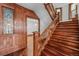 Grand foyer featuring a beautiful stained glass window, wood paneling, staircase and hardwood floors at 1563 N Lafayette St, Denver, CO 80218