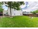 Expansive backyard featuring lush green lawn, privacy fencing, and mature shade trees at 4800 S Tabor St, Morrison, CO 80465