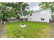 Large backyard featuring a well-kept lawn, mature trees, and the home's exterior with multiple windows at 4800 S Tabor St, Morrison, CO 80465