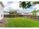 Spacious backyard with lush green lawn, wooden fence, and a built-in fire pit area at 4800 S Tabor St, Morrison, CO 80465
