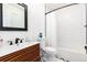 Modern bathroom with a stylish vanity, black hardware, and a shower-tub combination at 4800 S Tabor St, Morrison, CO 80465