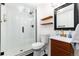 Sleek bathroom features a glass-enclosed shower, floating shelves, and a modern vanity at 4800 S Tabor St, Morrison, CO 80465