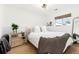 Comfortable bedroom with neutral colors, area rug, and a woven nightstand at 4800 S Tabor St, Morrison, CO 80465
