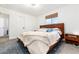 Comfortable bedroom with a wood frame bed, neutral tones, and natural light from the window at 4800 S Tabor St, Morrison, CO 80465