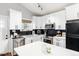 Modern kitchen with stainless steel appliances, white cabinets, and dark backsplash at 4800 S Tabor St, Morrison, CO 80465