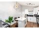 Modern kitchen with a center island, white cabinets, and contemporary lighting at 4800 S Tabor St, Morrison, CO 80465