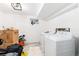 Functional laundry room with washer, dryer, and storage space for cleaning supplies at 4800 S Tabor St, Morrison, CO 80465