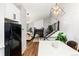 Bright living room with a fireplace, stairs and view from kitchen at 4800 S Tabor St, Morrison, CO 80465