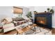 Comfortable living room showcasing a fireplace, sofa, and decorative coffee table at 4800 S Tabor St, Morrison, CO 80465