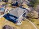 Aerial view of home and manicured yard featuring beautiful landscaping, patio area, and mature trees at 6111 W Fremont Dr, Littleton, CO 80128