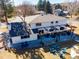 Aerial view of the backyard featuring an outdoor entertaining space with a pergola, fireplace, seating, and fire pit at 6111 W Fremont Dr, Littleton, CO 80128