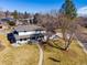 Lovely aerial view of a two-story home with a large front yard and mature trees, providing curb appeal and shade at 6111 W Fremont Dr, Littleton, CO 80128