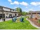 Spacious backyard boasts a charming fire pit area and a covered patio, ideal for relaxing and entertaining at 6111 W Fremont Dr, Littleton, CO 80128