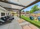 Relaxing backyard with lounge seating under a pergola, fire pit, and landscaped yard perfect for outdoor enjoyment at 6111 W Fremont Dr, Littleton, CO 80128