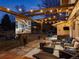 Cozy backyard patio with outdoor seating, a fire pit, and string lights, creating a relaxing entertainment space at 6111 W Fremont Dr, Littleton, CO 80128