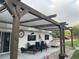 A pergola with shade covering creates an outdoor living space with comfortable seating for relaxation and entertaining at 6111 W Fremont Dr, Littleton, CO 80128