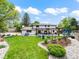 Expansive backyard with lush landscaping, a cozy fire pit area, and a covered patio perfect for outdoor gatherings at 6111 W Fremont Dr, Littleton, CO 80128