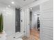 Modern shower with a glass door, contrasting tile, and access to closet/bedroom at 6111 W Fremont Dr, Littleton, CO 80128