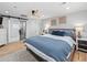 Comfortable bedroom with hardwood floors, stylish light fixtures, and cool color palette at 6111 W Fremont Dr, Littleton, CO 80128