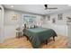 Comfortable bedroom with hardwood floors, wainscoting, and natural light from the window at 6111 W Fremont Dr, Littleton, CO 80128
