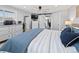Bright bedroom featuring a sliding door, white dresser, and a modern ceiling fan at 6111 W Fremont Dr, Littleton, CO 80128