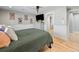 Cozy bedroom featuring wainscoting, hardwood floors, and neutral color scheme at 6111 W Fremont Dr, Littleton, CO 80128